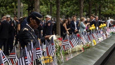 Colonel Davis looks at a photorgaph of her colleague, Captain Micheal Dermott Mullan, at the 9/11 Memorial in New York City. (AFP) Colonel Davis looks at a photorgaph of her colleague, Captain Micheal Dermott Mullan, at the 9/11 Memorial in New York City. (AFP)