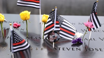 Flags and flowers are placed at the 9/11 Memorial and Museum.&nbsp; (REUTERS)