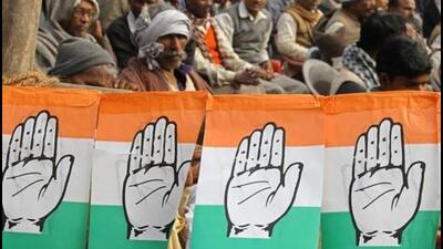 Congress party workers sit next to flags of party's logo. (Reuters) Congress party workers sit next to flags of party's logo. (Reuters)