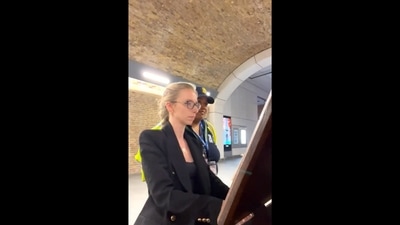 The image, taken from the viral video, shows Anna and Marcella paying a musical tribute to Queen Elizabeth II at London Bridge station. &nbsp; (Twitter/@annalapwood)