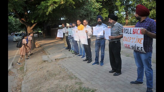 Parents protesting outside Ryan International School in Sector 49, Chandigarh, on Monday. (Ravi Kumar/HT)
