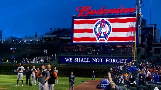 San Francisco Giants players pause for remembrance of the 9/11 tragedy before the team's game against the Chicago Cubs at Wrigley Field.(USA TODAY Sports)