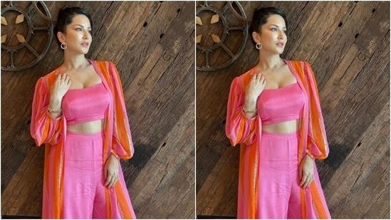 Sunny, for Hyderabad promotions, decked up in a silk slip pink cropped top and teamed it with a pair of pink silk palazzos with wide legs. She added more drama to her look with a silk pink and orange oversized shrug featuring stripes in silver resham threads and puffy full sleeves.(Instagram/@sunnyleone)