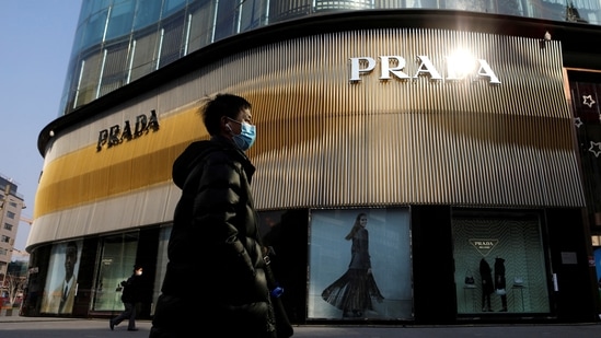 A man wearing a face mask walks past a store of Italian luxury brand Prada on a shopping street in Beijing, China, January 20, 2021.(REUTERS)