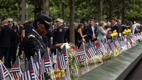 Colonel Davis looks at a photorgaph of her colleague, Captain Micheal Dermott Mullan, at the 9/11 Memorial in New York City. (AFP)