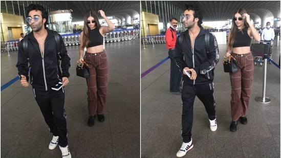 Tara styled the airport look with black combat boots, a black and orange top handle bag, dainty earrings, and black tinted Lennon-style sunglasses. A centre-parted open hairdo, glossy pink lip shade, blushed cheeks, and glowing skin completed the glam picks.(HT Photo/Varinder Chawla)