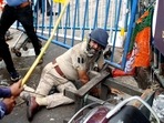 An assistant commissioner of Kolkata Police attacked by protesters amid BJP's 'Nabanna Chalo' march against the state government in Kolkata on Tuesday. (ANI ) An assistant commissioner of Kolkata Police attacked by protesters amid BJP's 'Nabanna Chalo' march against the state government in Kolkata on Tuesday. (ANI )