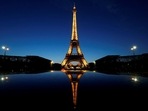 A night view shows the Eiffel tower, reflected in a car's roof, in Paris, France.
