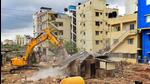 A Bruhat Bengaluru Mahanagara Palike bulldozer demolishes an illegal structure built on storm-water drain in Munnekolala area, which was recently flooded due to heavy monsoon rains, in Bengaluru. (PTI) A Bruhat Bengaluru Mahanagara Palike bulldozer demolishes an illegal structure built on storm-water drain in Munnekolala area, which was recently flooded due to heavy monsoon rains, in Bengaluru. (PTI)