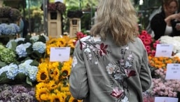 Queen Elizabeth II's funeral: Customers line up to buy flowers at a stall at the Columbia Road Flower Market in east London.