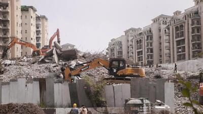 Debris clearance work underway at the site of the demolished twin towers of Supertech, in Noida. (PTI) Debris clearance work underway at the site of the demolished twin towers of Supertech, in Noida. (PTI)