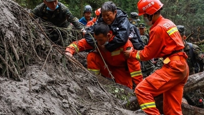 China Sichuan Earthquake: Paramilitary police officers and rescuers evacuate residents in China's Sichuan. (AFP)