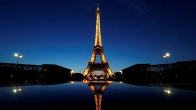 A night view shows the Eiffel tower, reflected in a car's roof, in Paris, France. (REUTERS)