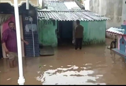 A man standing outside his flooded home. (ANI)