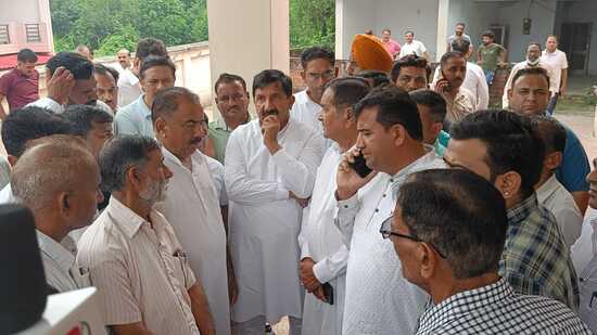 Leader of opposition in HP Mukesh Agnihotri with family members and locals outside RH, Una on Tuesday. (HT Photo)