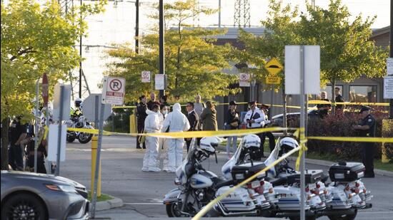 Police officers and investigators work the scene of a shooting in Mississauga, Ontario, on Monday. (AP)