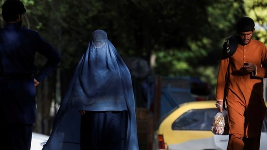 Afghanistan: An Afghan woman walks on a street in Kabul, Afghanistan.