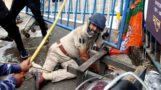 An assistant commissioner of Kolkata Police attacked by protesters amid BJP's 'Nabanna Chalo' march against the state government in Kolkata on Tuesday.&nbsp;(ANI )