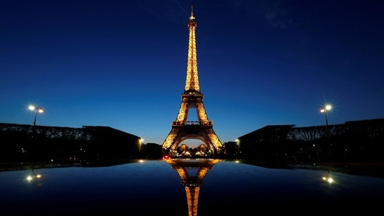 A night view shows the Eiffel tower, reflected in a car's roof, in Paris, France.(REUTERS)