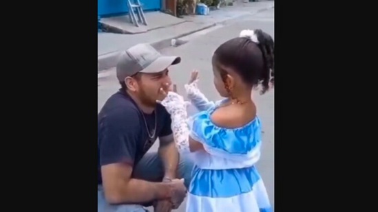 The image, taken from the Instagram video, shows the daughter showing her dad at his workplace how she dressed up for her school function. (Instagram/@goodnews_movement)