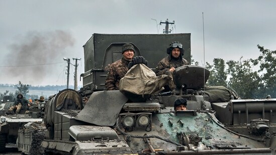 Ukrainian military vehicles move on the road in the freed territory of the Kharkiv region, Ukraine.&nbsp;(AP)