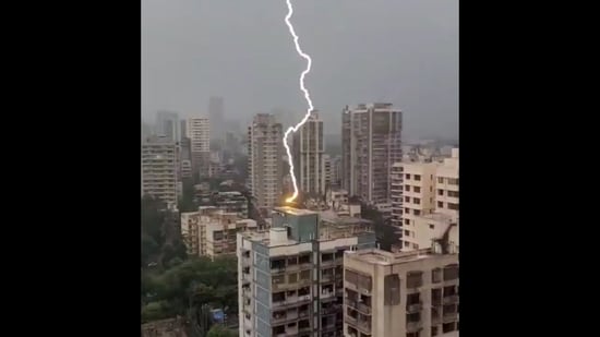 The image, taken from the viral Instagram video, shows a bolt of lightning striking a high-rise building in Mumbai's Borivali West.(Instagram/@vibhutibandekar)