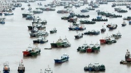 An aerial view shows boats moored at a fishing port as Typhoon Mufa approaches the city of Zhoushan in China's Zhejiang province.