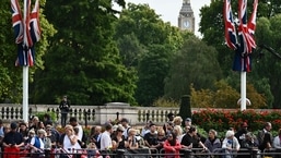 Members of the public wait in London head of the ceremonial procession of the coffin of Queen Elizabeth II, from Buckingham Palace to Westminster Hall. 