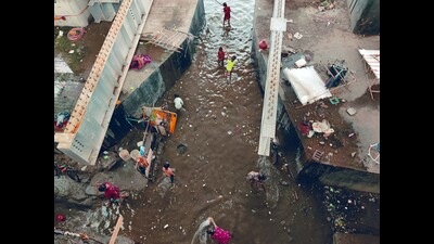 Women and children from the slums near Mutha riverbed try to remove water that entered their homes due to rains and increased water level in the river on Wednesday. (Rahul Raut/HT PHOTO) Women and children from the slums near Mutha riverbed try to remove water that entered their homes due to rains and increased water level in the river on Wednesday. (Rahul Raut/HT PHOTO)