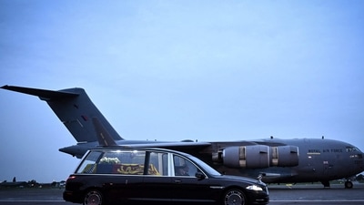The coffin of Queen Elizabeth II is taken away in the Royal Hearse from the Royal Air Force Northolt airbase to travel to Buckingham Palace. (AFP) The coffin of Queen Elizabeth II is taken away in the Royal Hearse from the Royal Air Force Northolt airbase to travel to Buckingham Palace. (AFP)