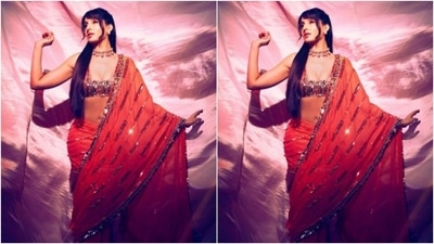 Nora looked every bit amazing in an orange sequined saree, intricately embroidered in silver resham threads. She teamed it with a heavily embellished silver and orange blouse with a square-cut plunging neckline. (Instagram/@norafatehi)