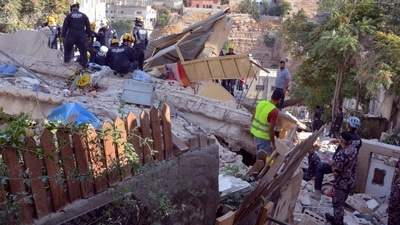 Jordan Building Collapse: Civil defence members search for survivors at the site of a four-storey residential building collapse in Amman, Jordan. (Reuters)