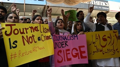 Journalists and employees of ARY News, a private news channel, chant slogans and hold placards during a protest against the channel being taken off air by the government. (AFP) Journalists and employees of ARY News, a private news channel, chant slogans and hold placards during a protest against the channel being taken off air by the government. (AFP)