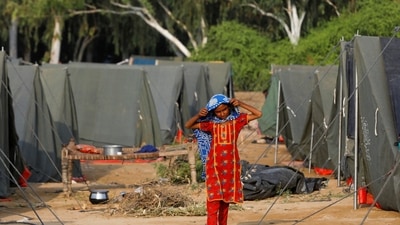 A girl whose family became displaced walks amid tents, following rains and floods during the monsoon season in Sehwan, Pakistan. (Reuters)