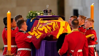The bearer party carries the coffin of Queen Elizabeth II into Westminster Hall, London on Wednesday. (AP)