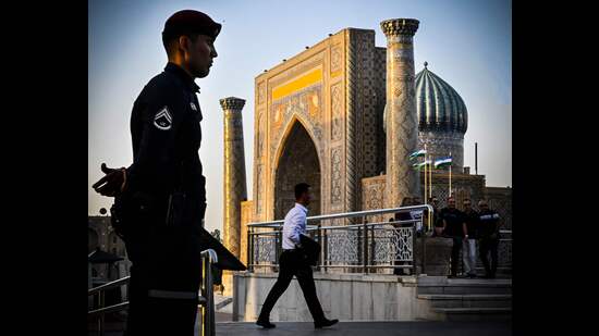 People stand in front of the Registan square in downtown Samarkand on September 13, 2022 (AFP)