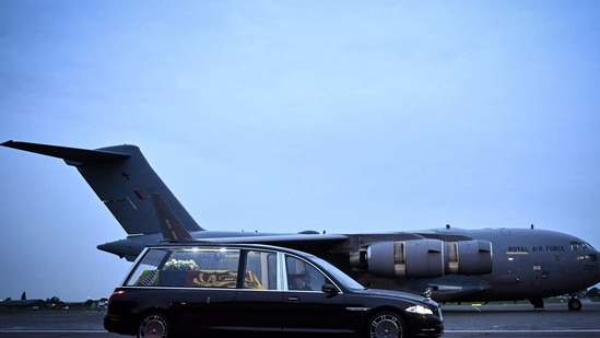 The coffin of Queen Elizabeth II is taken away in the Royal Hearse from the Royal Air Force Northolt airbase to travel to Buckingham Palace.(AFP)