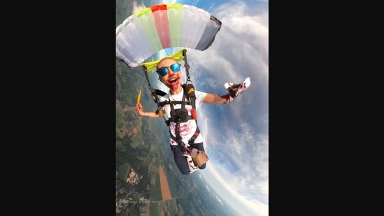 The image, taken from the viral Instagram video, shows the woman eating pie while skydiving.(Instagram/@mckennaknipe)