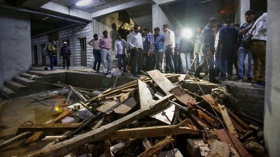 Ahmedabad: Debris lie on the ground after the elevator of an under-construction building crashed, in Ahmedabad, Wednesday.(PTI) Ahmedabad: Debris lie on the ground after the elevator of an under-construction building crashed, in Ahmedabad, Wednesday.(PTI)