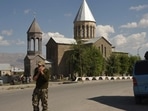 Armenia-Azerbaijan Conflict: A military volunteer speaks on a phone in the city of Vardenis,