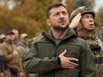 In this photo provided by the Ukrainian Presidential Press Office, President Volodymyr Zelenskyy, center, sings the Ukrainian national anthem during his visit to the city of Izium, Kharkiv region, Ukraine.(AP) In this photo provided by the Ukrainian Presidential Press Office, President Volodymyr Zelenskyy, center, sings the Ukrainian national anthem during his visit to the city of Izium, Kharkiv region, Ukraine.(AP)