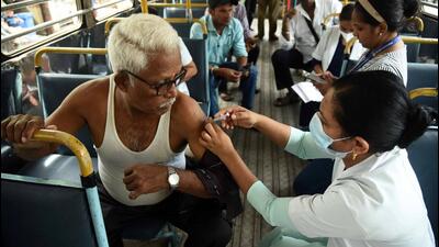 A beneficiary gets inoculated with the booster dose inside an NMMT bus in Navi Mumbai Bachchan Kumar/HT Photo