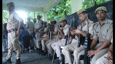 Security personnel outside a mortuary during post-mortem examination of one of two minor Dalit sisters allegedly raped and murdered in Lakhimpur Kheri, Thursday. (PTI Photo) Security personnel outside a mortuary during post-mortem examination of one of two minor Dalit sisters allegedly raped and murdered in Lakhimpur Kheri, Thursday. (PTI Photo)