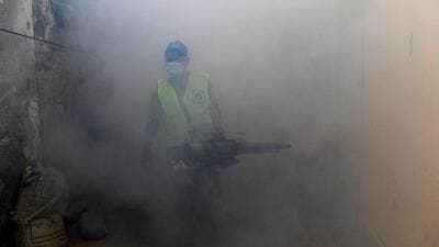 A worker sprays insecticide to kill dengue mosquitoes along a street. The district administration has shared two helpline numbers — 18001801817 and 0124-44055779 — on which residents can call between 9am and 5pm to request fogging drives in their area. (Representational image/AFP)