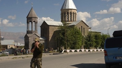 Armenia-Azerbaijan Conflict: A military volunteer speaks on a phone in the city of Vardenis, (AFP)