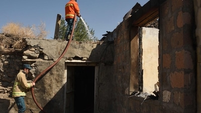 Armenia- Azerbaijan Conflict: Firefighters water the ruins of a house, which is said was hit by Azeri shelling during recent border clashes with Azerbaijan. (AFP) Armenia- Azerbaijan Conflict: Firefighters water the ruins of a house, which is said was hit by Azeri shelling during recent border clashes with Azerbaijan. (AFP)