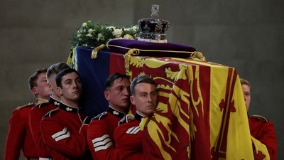 The Queen's coffin was topped by a wreath of white roses and her crown resting on a purple velvet pillow. (REUTERS)