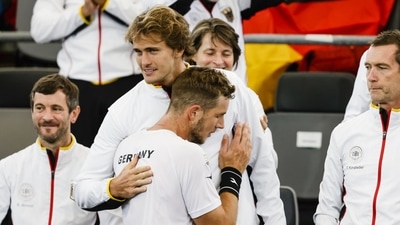 Germany's Jan-Lennard Struff, front, celebrates with teammate Alexander Zverev after defeating Benjamin Bonzi of France in a Davis Cup group C match (AP) Germany's Jan-Lennard Struff, front, celebrates with teammate Alexander Zverev after defeating Benjamin Bonzi of France in a Davis Cup group C match (AP)