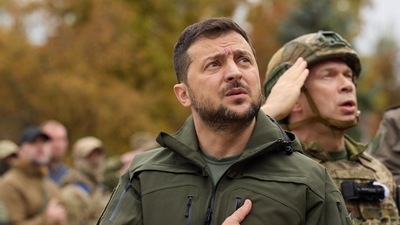 In this photo provided by the Ukrainian Presidential Press Office, President Volodymyr Zelenskyy, center, sings the Ukrainian national anthem during his visit to the city of Izium, Kharkiv region, Ukraine. (AP) In this photo provided by the Ukrainian Presidential Press Office, President Volodymyr Zelenskyy, center, sings the Ukrainian national anthem during his visit to the city of Izium, Kharkiv region, Ukraine. (AP)