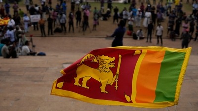 Sri Lanka Crisis: A Sri Lankan flag is waved by a protester in Colombo, Sri Lanka. (AP File)